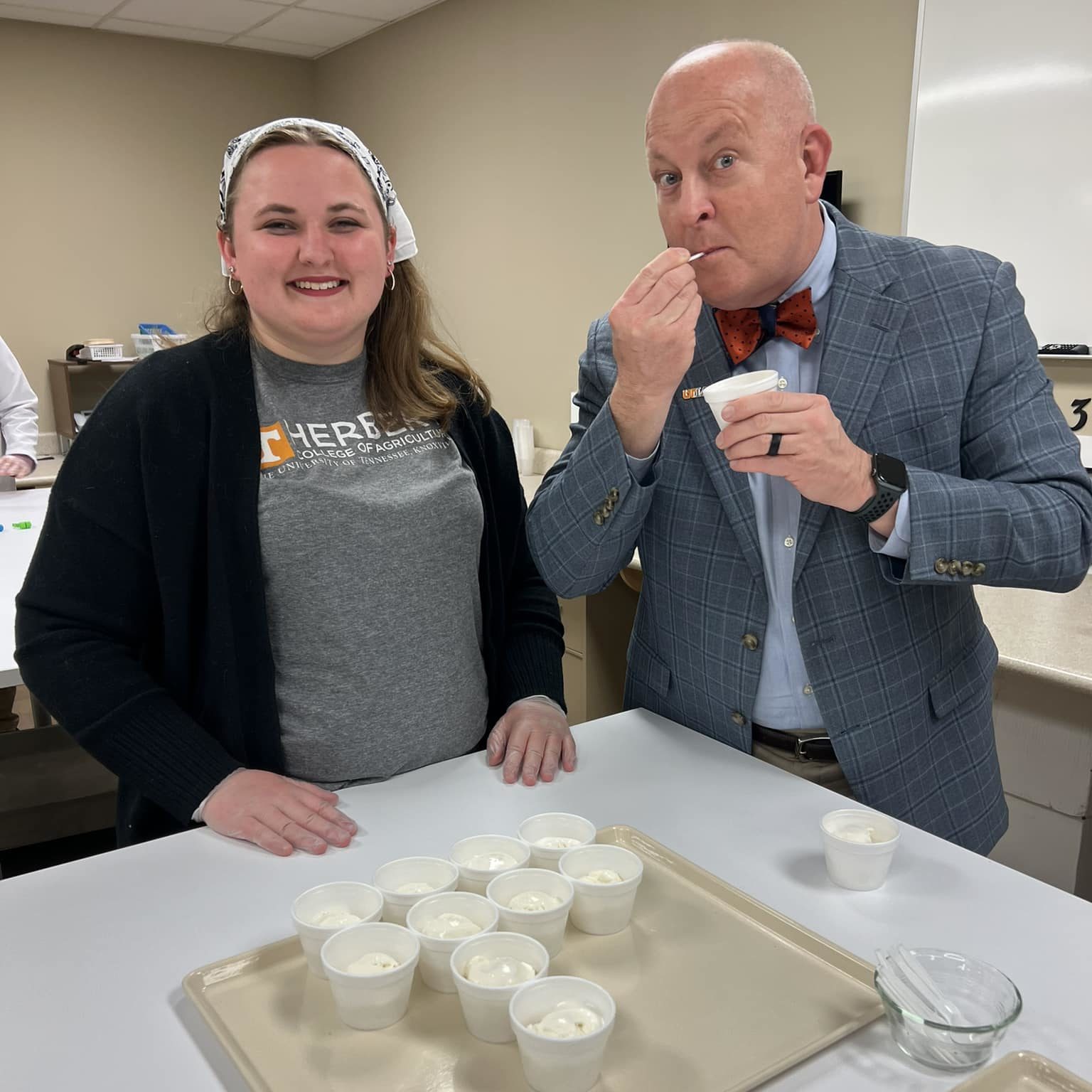 Senior Vice Chancellor and Senior Vice President Keith Carver with a food science student taste testing ice cream